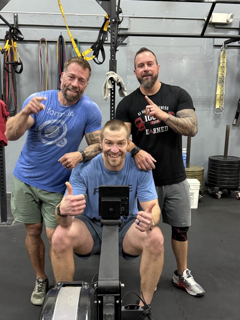 A Row-A-Thon team posing around their rower