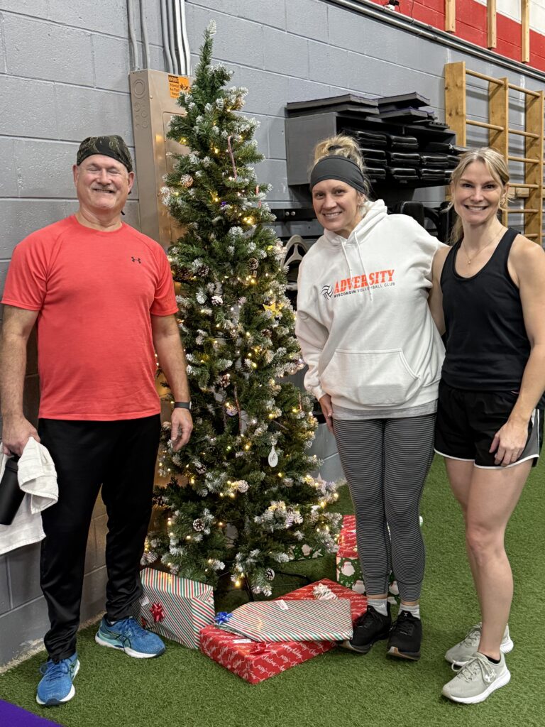 A Row-A-Thon team standing by the Christmas tree