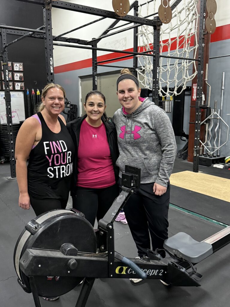 A team of three next to their rower at last year's event