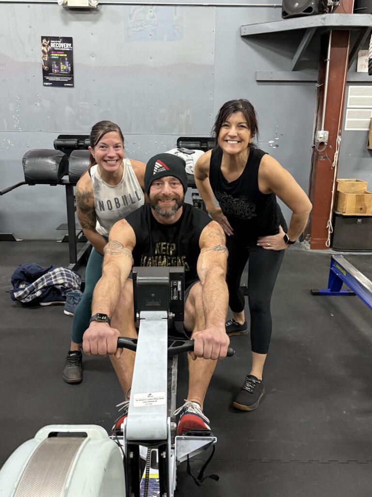 A Row-A-Thon team gathered around their rower